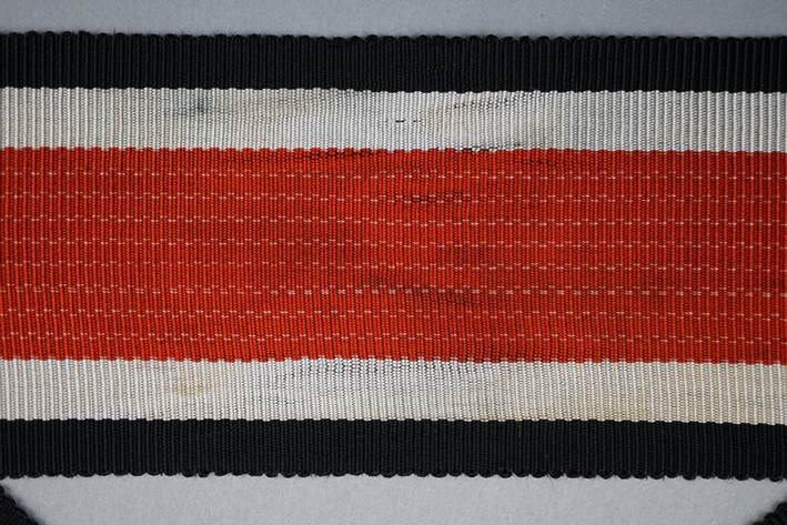 A red and black striped rug

Description automatically generated