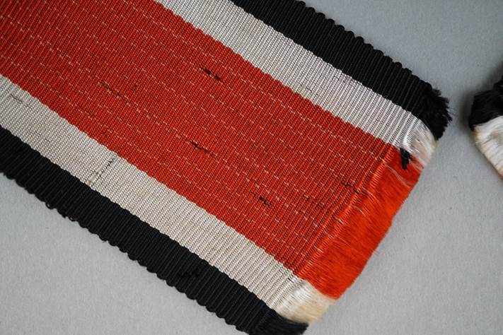 A close up of a red white and black striped rug

Description automatically generated