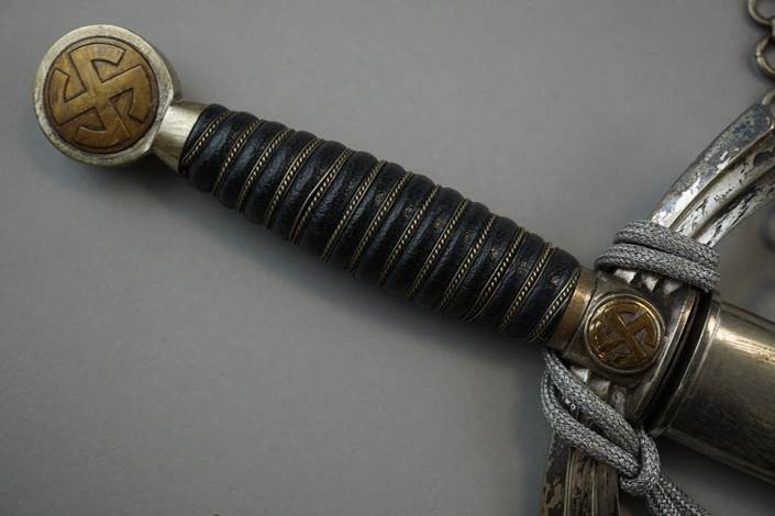 A close-up of a sword

Description automatically generated