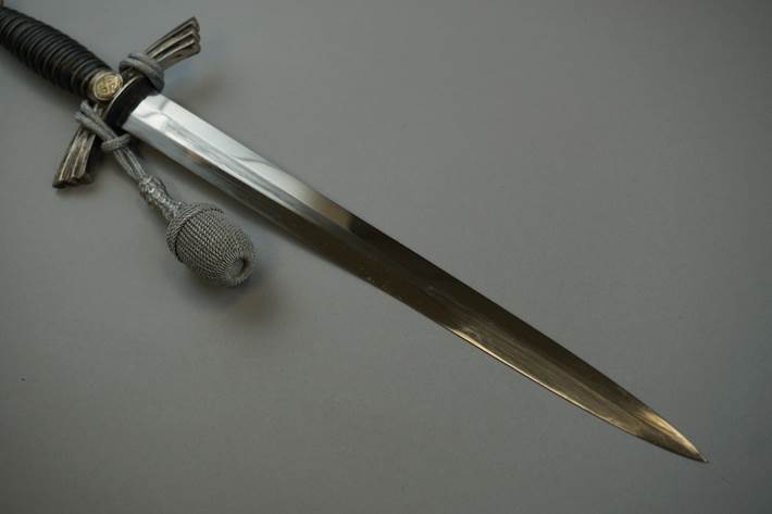 A close-up of a sword

Description automatically generated