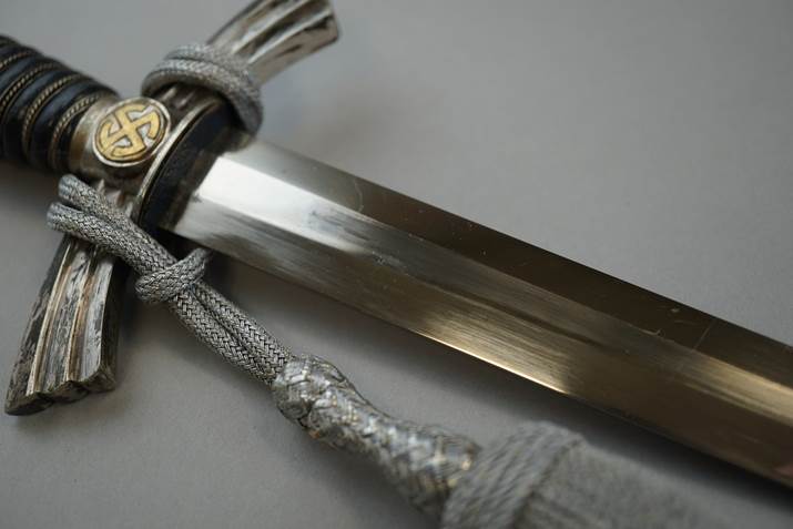 A close-up of a sword

Description automatically generated