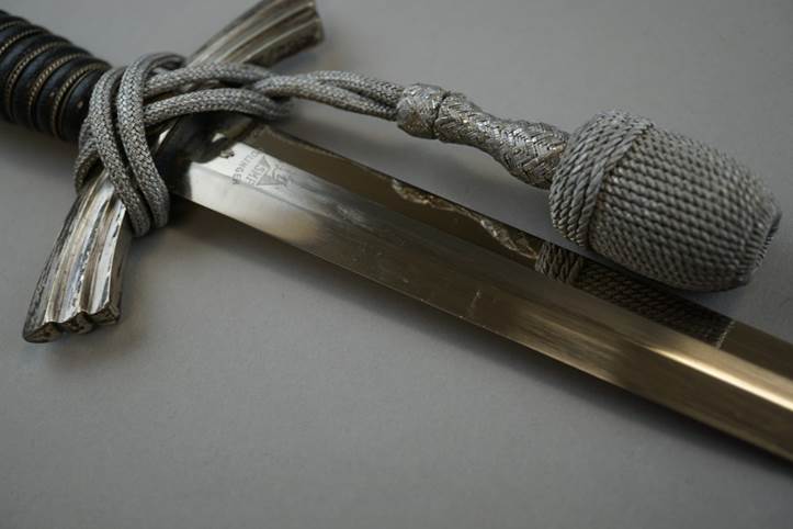 A close-up of a sword

Description automatically generated