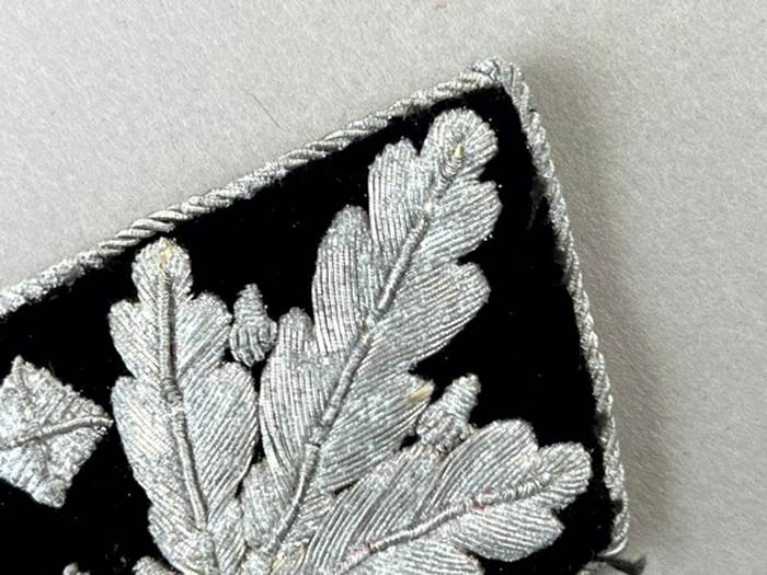 Close-up of a black and white embroidered patch

Description automatically generated