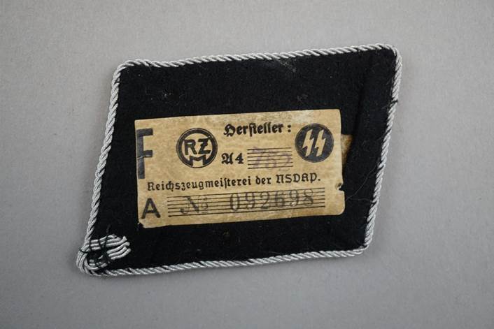 A black and white patch with a label

Description automatically generated