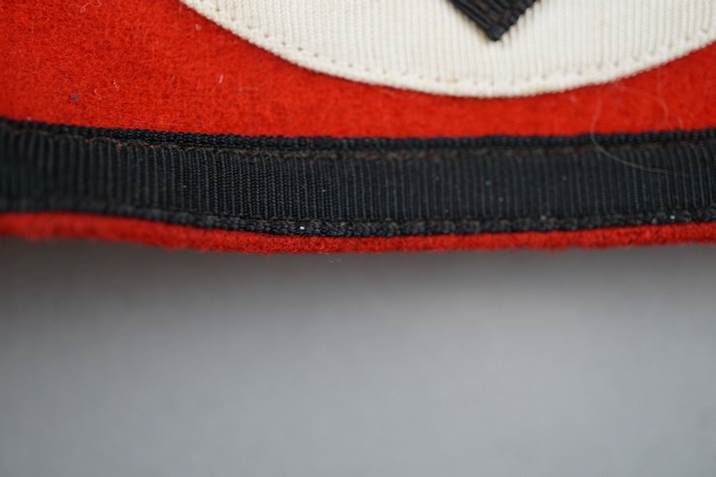 Close-up of a red and white patch

Description automatically generated