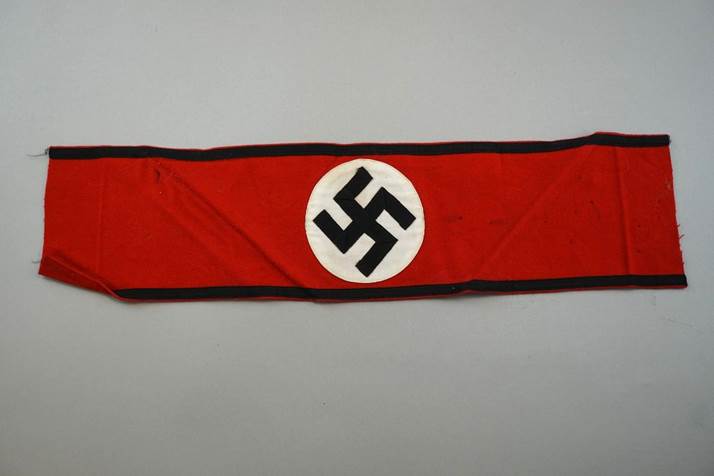 A red and black scarf with a swastika

Description automatically generated