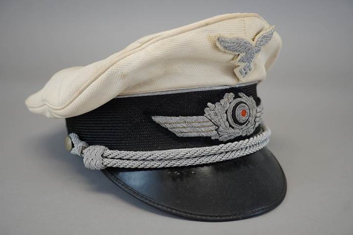 A white and black hat with a gray and black band

Description automatically generated