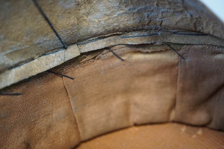 Close-up of a cushion with a stitched edge

Description automatically generated