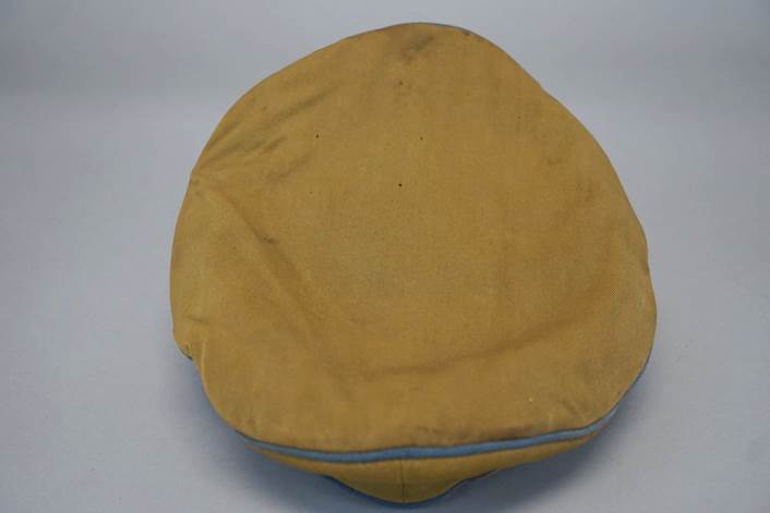 A yellow beanie with blue stitching

Description automatically generated