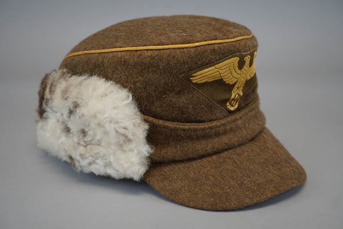 A brown hat with a white fur ear flaps

Description automatically generated