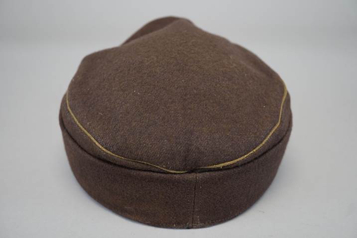 A brown hat with a yellow stitching

Description automatically generated