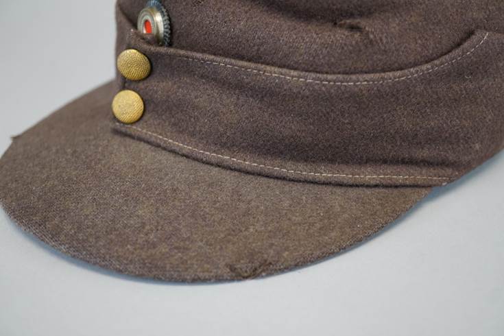 A brown hat with buttons

Description automatically generated