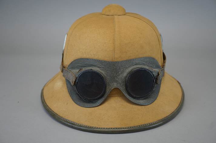 A hat with goggles on it

Description automatically generated