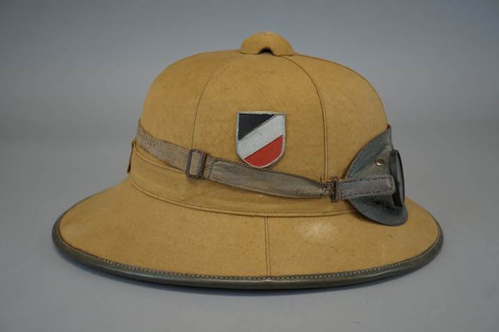 A brown hat with a patch on it

Description automatically generated