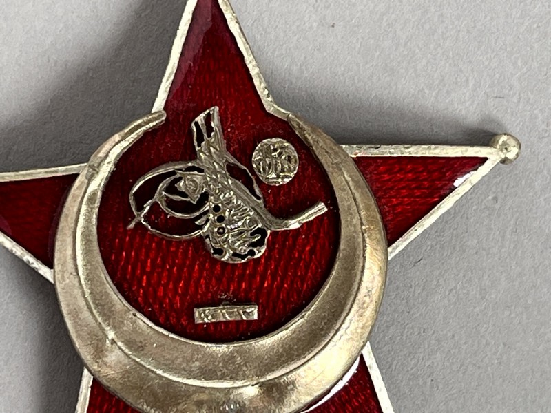 A red and gold star with a crescent and a football ball

AI-generated content may be incorrect.