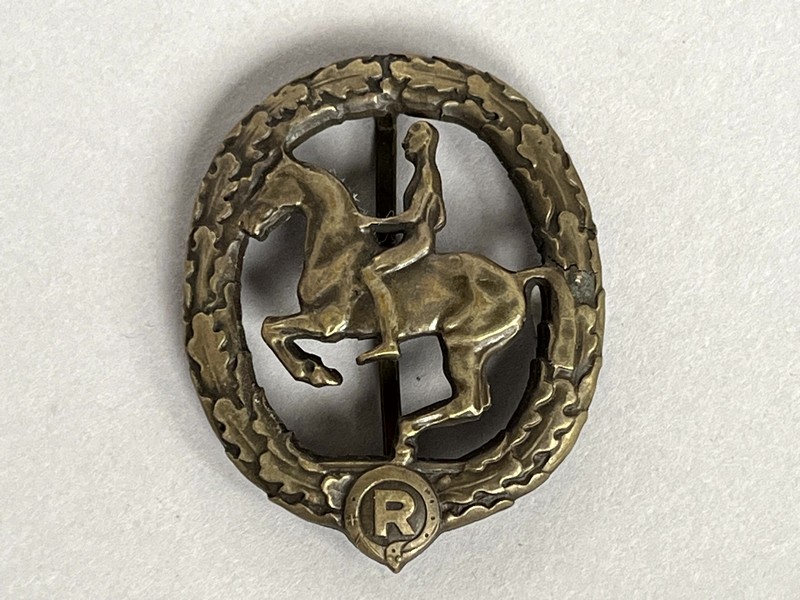 A metal badge with a horse and a symbol

AI-generated content may be incorrect.
