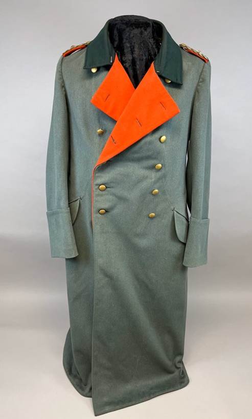 A long grey coat with orange patch

AI-generated content may be incorrect.