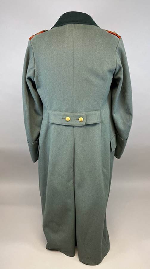 A long green coat with yellow buttons

AI-generated content may be incorrect.