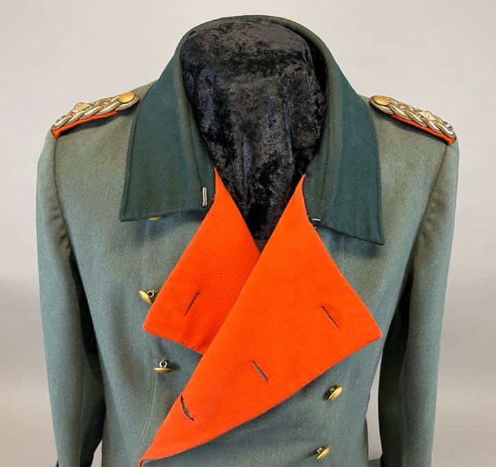 A jacket with an orange scarf on it

AI-generated content may be incorrect.