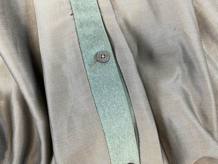 A close up of a button on a shirt

AI-generated content may be incorrect.