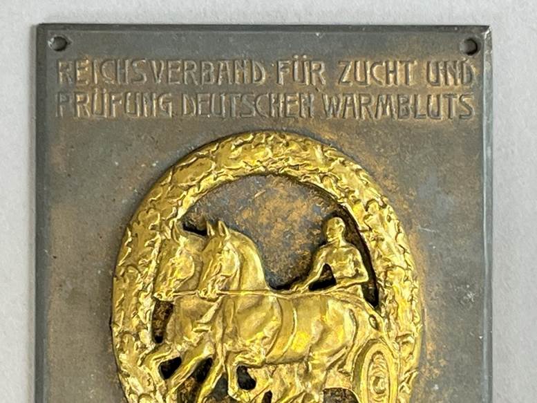 A plaque with a picture of a person riding a horse

AI-generated content may be incorrect.