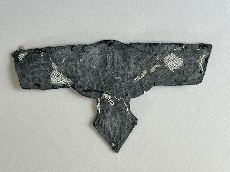 A black piece of paper with white thread

AI-generated content may be incorrect.