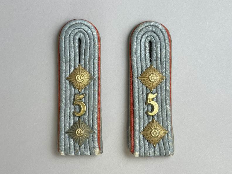 A pair of shoulder straps with numbers

AI-generated content may be incorrect.