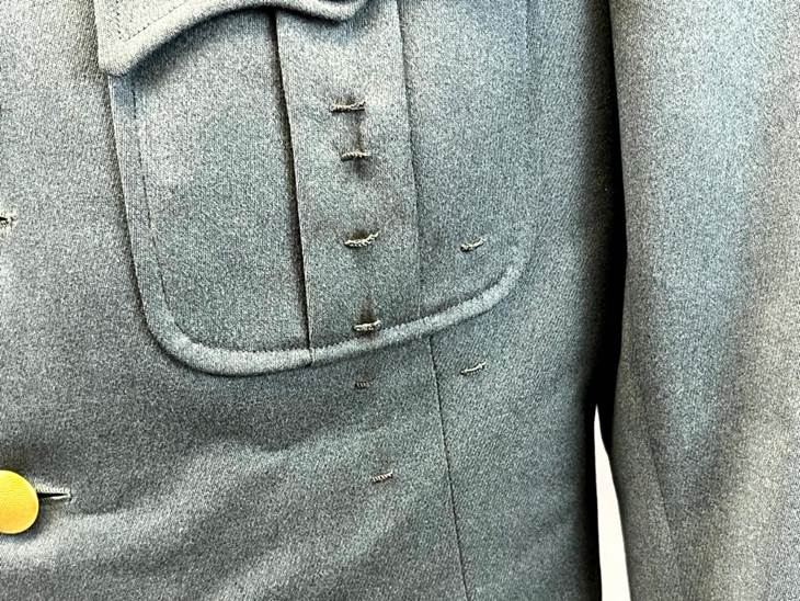 Close-up of a suit with a few holes in it

AI-generated content may be incorrect.