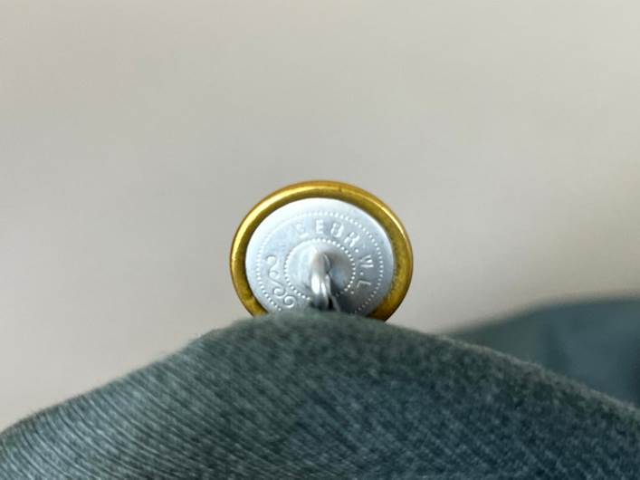 A close-up of a button

AI-generated content may be incorrect.