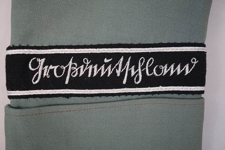 A black and white patch with white writing on it

AI-generated content may be incorrect.