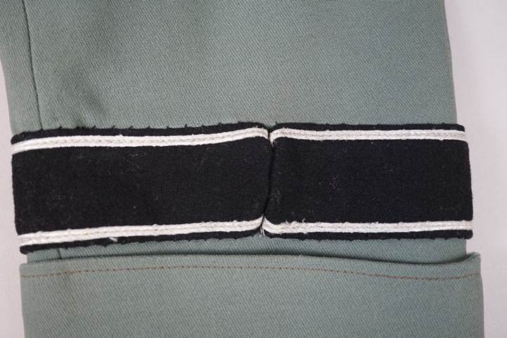A black and white patch on a green fabric

AI-generated content may be incorrect.