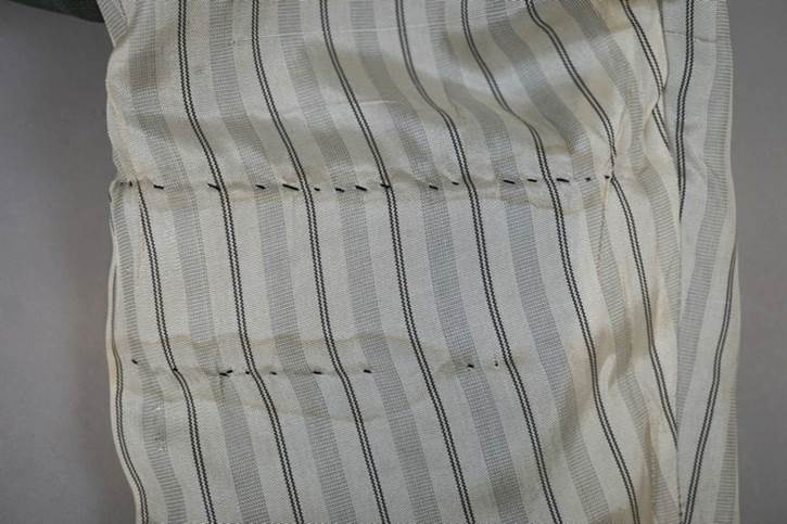 A close-up of a white and black striped pillow

AI-generated content may be incorrect.