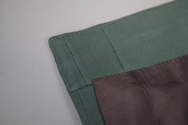 A close-up of a green and brown cloth

AI-generated content may be incorrect.