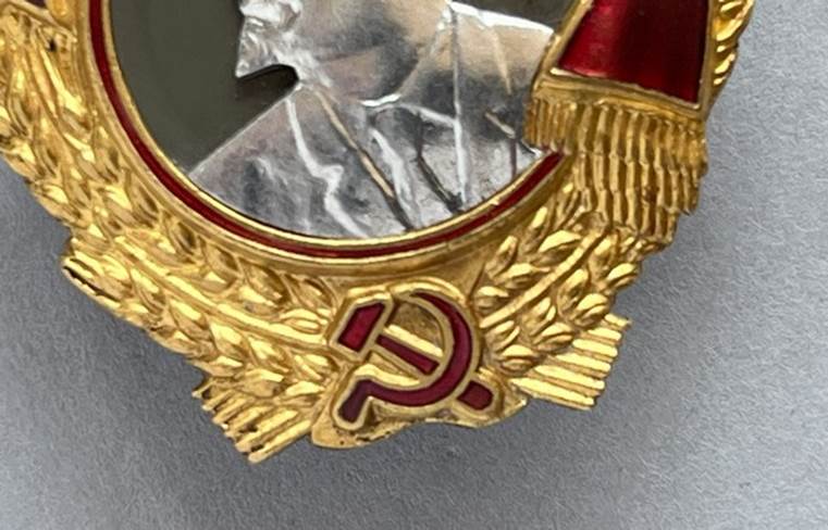 A gold and red emblem

AI-generated content may be incorrect.