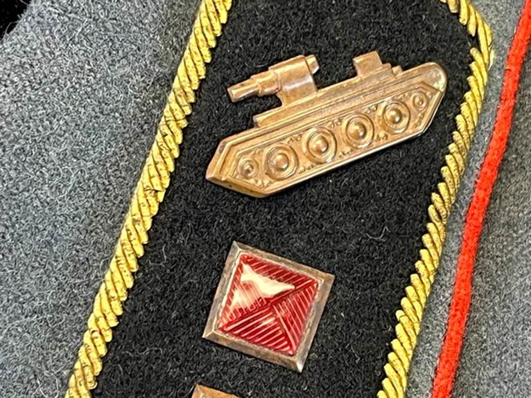 A close up of a military uniform

AI-generated content may be incorrect.