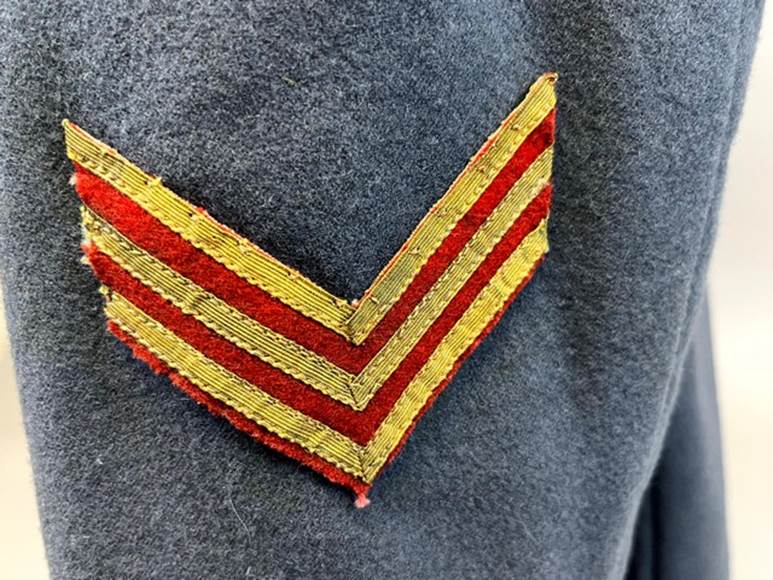 A red and yellow patch on a grey jacket

AI-generated content may be incorrect.