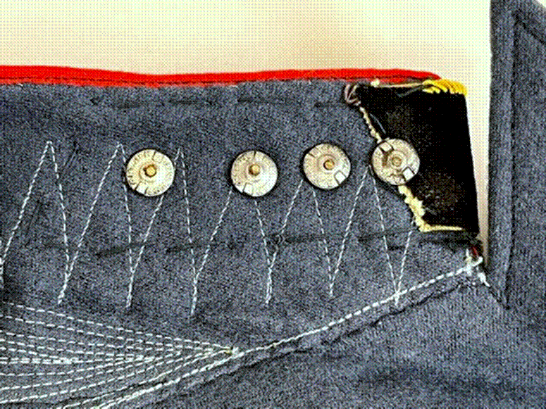 Close-up of a buttoned fabric

AI-generated content may be incorrect.