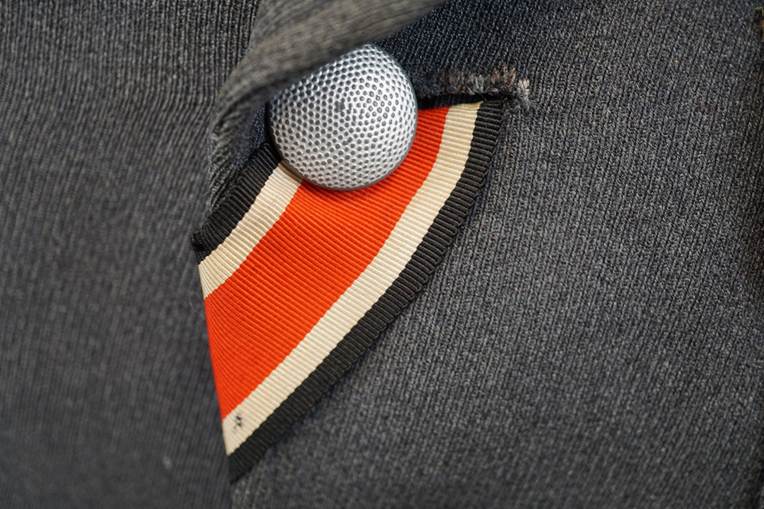 A close-up of a microphone in a suit

AI-generated content may be incorrect.