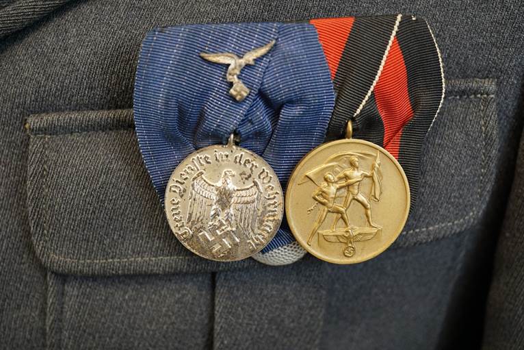 A close-up of medals

AI-generated content may be incorrect.