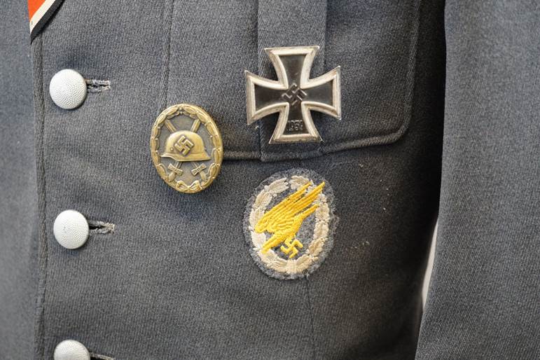 A close-up of a jacket with patches

AI-generated content may be incorrect.