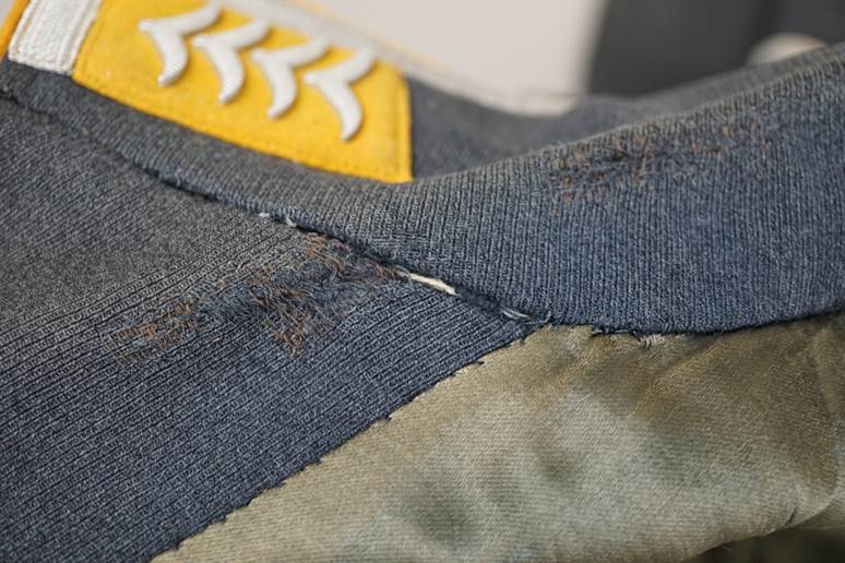 Close-up of a patched piece of clothing

AI-generated content may be incorrect.
