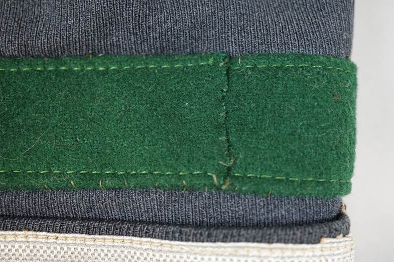 A green patch on a grey fabric

AI-generated content may be incorrect.