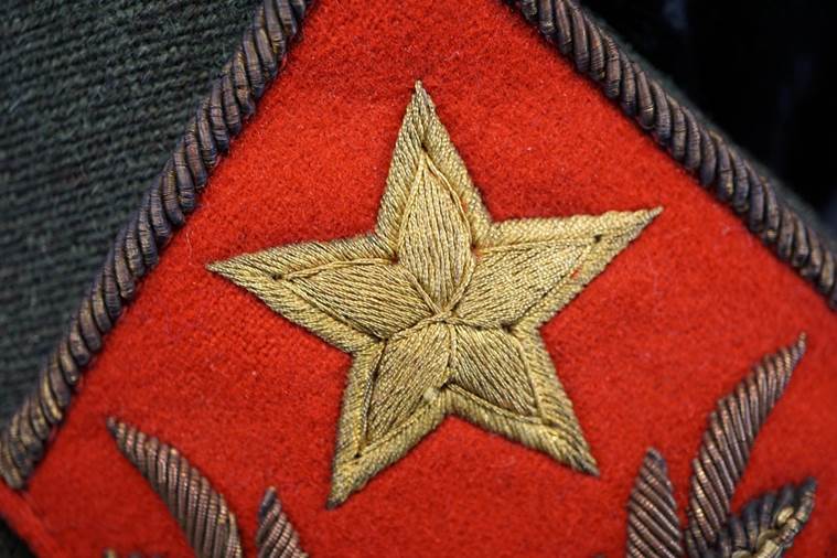 A close-up of a red and gold patch

AI-generated content may be incorrect.