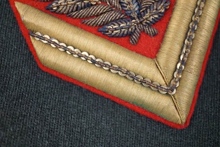 Close-up of a red and gold patch

AI-generated content may be incorrect.