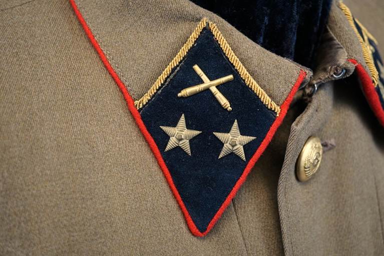A close-up of a military uniform

AI-generated content may be incorrect.