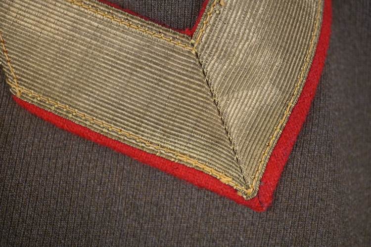 A close-up of a red and gold patch

AI-generated content may be incorrect.