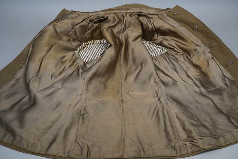 A brown jacket with holes in it

AI-generated content may be incorrect.