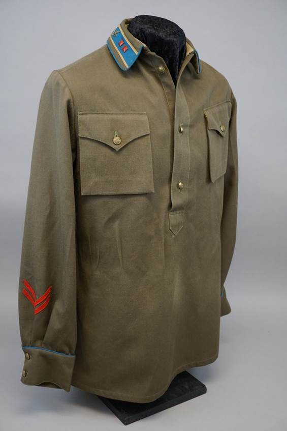 A green military jacket with a red stripe on the sleeve

AI-generated content may be incorrect.