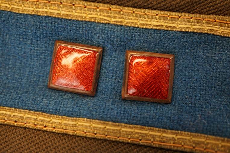 Two red square buttons on a blue fabric

AI-generated content may be incorrect.
