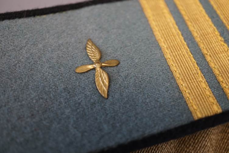 Close-up of a blue and gold uniform

AI-generated content may be incorrect.